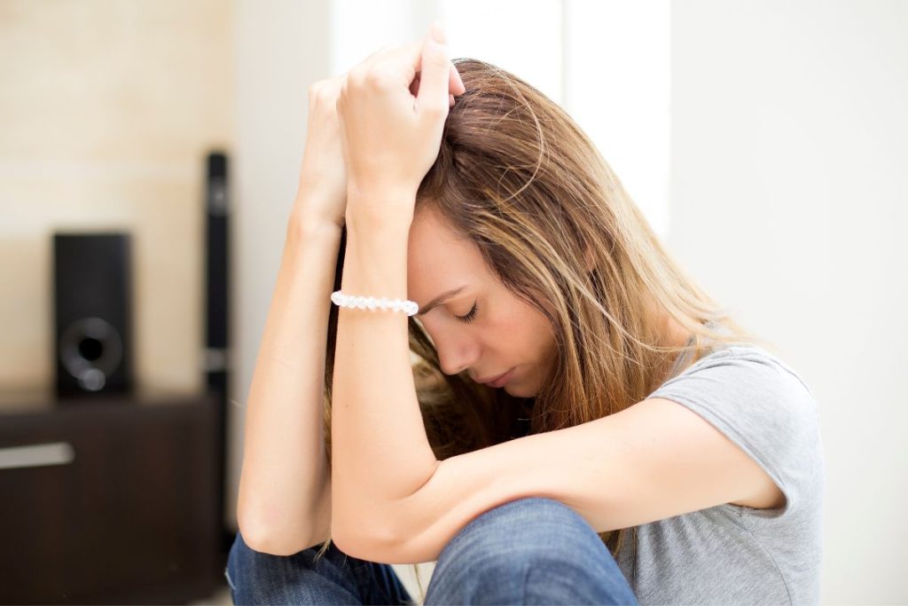 Sad woman in her room - tranquilshores.org